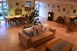 a living room with a couch and a dining room at Chambres d'Hôtes S'burehiesel in Schillersdorf