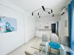 a dining room with a glass table and chairs at SANDY BAY Villa in Ayia Napa
