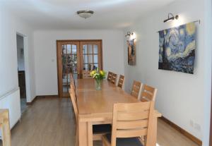 a dining room with a wooden table and chairs at Auburn Cottage in Arbroath +39 photos