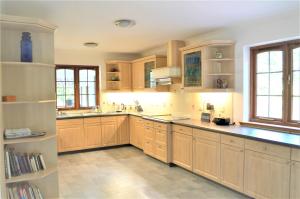 a large kitchen with wooden cabinets and counters at Auburn Cottage in Arbroath