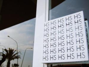 a sign with the words his his his his hisiths on a building at Hotel Salus in Pescara