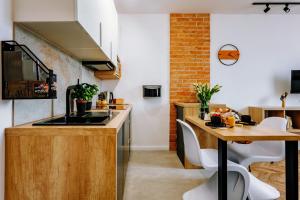 a kitchen with a wooden counter and a table at KOZAcki Kwadrat in Lublin
