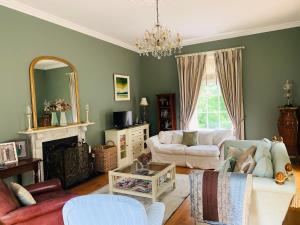 a living room with a couch and a fireplace at Larchmount House B&B in Derry Londonderry