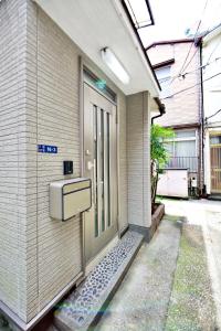 an entrance to a building with a door at Mita Kodate - Vacation STAY 8863 in Tokyo