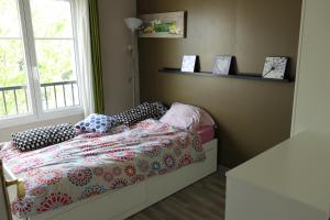 a small bedroom with a bed and a window at Ma Grace in Savigny-le-Temple