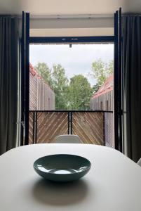 a black plate sitting on a table in front of a window at Apartment KOPA in Pervalka +9 photos