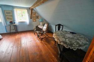 a room with a table and a chair in a attic at Chalupa Huníkov in Huníkov