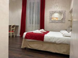 a bedroom with a bed and a dresser at Antico Hotel Moderno in Piombino