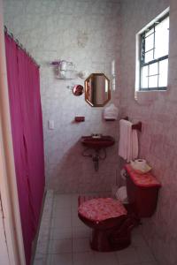 
a bathroom with a toilet, sink, and tub at Hotel Casa de la Luna in San Juan Teotihuacán

