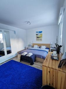 a bedroom with a blue bed and a blue rug at 4P Apartment in Andermatt