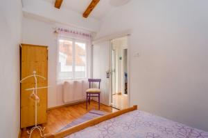 Postel nebo postele na pokoji v ubytování Apartments Kaštel