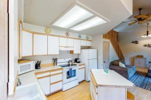 a kitchen with white appliances and a living room at Tanya's Beach Retreat in Pacific City