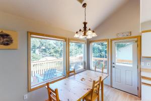 a dining room with a table and windows at Tanya's Beach Retreat in Pacific City