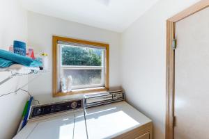 a small kitchen with a sink and a window at Tanya's Beach Retreat in Pacific City +15 photos
