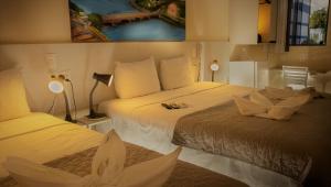 מיטה או מיטות בחדר ב-Pousada Elo Inn