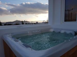 a bath tub with a view of the ocean at Polis of Naxos Boutique Hotel in Naxos Chora
