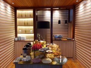 a buffet of food on a table in a room at Hotel Esplanada in Diamantina