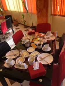 a table with plates of food on it at Flamenco Hotel in Sisian