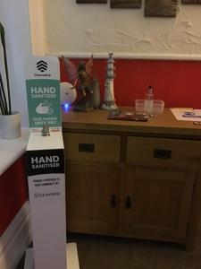 a stand for a hand manufacturer sign in a room at Lindisfarne Holiday Apartments - Families & Couples Only in Blackpool