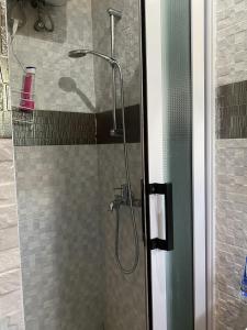 a shower in a bathroom with a glass door at [B] Bakerstreet - Beautiful Two Bedroom Apartment in Accra