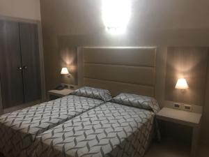 Postel nebo postele na pokoji v ubytování Hotel Niagara