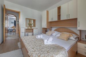 ein Schlafzimmer mit einem großen Bett mit Handtüchern darauf in der Unterkunft Apartments Barba in Tučepi
