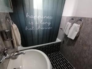 a bathroom with a shower with a toilet and a sink at Apartment ELLA in Tuzla +27 photos