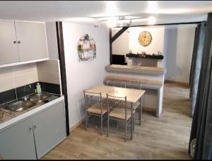 a kitchen with a table and chairs in a room at T2 bis quartier château de Pau in Pau