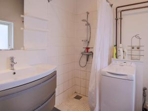 a white bathroom with a sink and a shower at 6 person holiday home in Slagelse in Slagelse