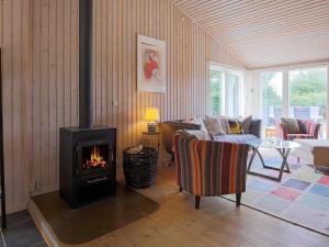 a living room with a wood stove in it at 6 person holiday home in Slagelse in Slagelse