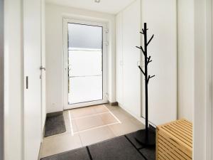 a hallway with a door and a tree in it at Holiday home Viroinval in Petigny