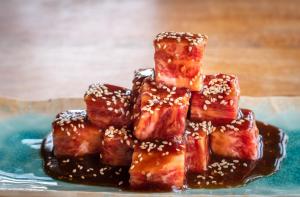 a pile of sticky food with sesame seeds on a plate at Ishigaki Sunset Cove in Ishigaki Island