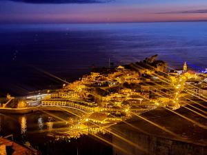 a cruise ship docked in a harbor at night at GuestReady - Sonho dos Avós in Câmara de Lobos