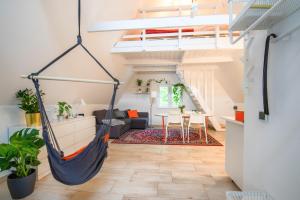 a loft with a hammock in a living room at Zawoja 1725 - Slow Life Cabins in Zawoja +41 photos