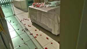 a bedroom with a bed with roses on the floor at Ocean View Hotel in Arraial do Cabo