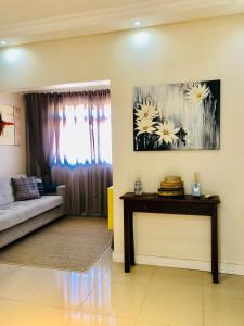 a living room with a couch and a table at Flat Blumenau Vila Nova in Blumenau