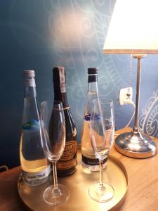 two bottles of champagne and two glasses on a table at Vita - Apartamenty przy ul Solankowej in Inowrocław