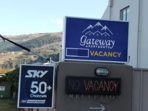 a sign for a calgary marriott pharmacy with a vacancy sign at Queenstown Gateway Apartments in Queenstown