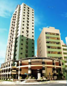 a large building with two tall buildings at Master Curitiba Hotel - 1,6 km do Estádio Couto Pereira - Show in Curitiba