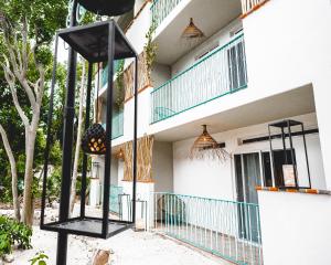 a building with two black poles in front of it at LA TULUMEÑA Boutique Hotel in Tulum