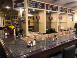 a bar in a restaurant with flowers on the counter at Wolf Inn Hotel in Sandusky