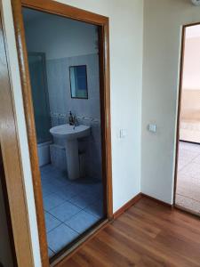 a bathroom with a sink and a tub and a mirror at Отель Транзит in Pervomayskīy