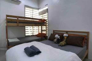 a bedroom with two bunk beds in a room at be.Animania -8-10mins Lost World Tambun -14-18pax in Ipoh
