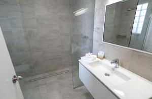 a bathroom with a sink, toilet and bathtub at Esplanade Hotel Busselton in Busselton