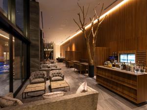 a lobby of a hotel with chairs and a bar at Garden Terrace Fukuoka in Fukuoka