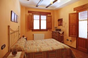 Cama o camas de una habitación en Casa Rural Rosa