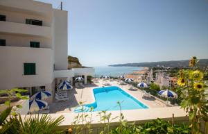 a view of a hotel with a swimming pool and the ocean at Svevo Sea House in Vieste