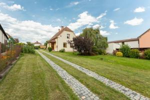 a cobblestone path in front of a house at VS apartmán in Turnov