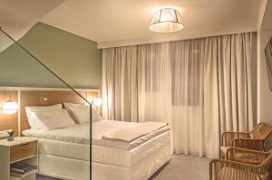 Ένα ή περισσότερα κρεβάτια σε δωμάτιο στο Eco Green Residences & Suites