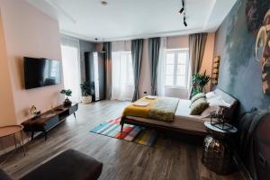 a bedroom with a large bed and a tv at Square 19-Boutique hotel in Novi Sad